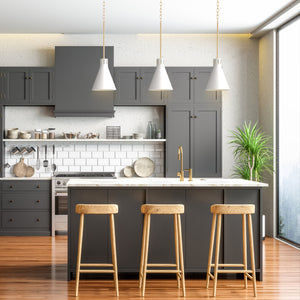 3 Conic white cone pendant lights above a kitchen island.